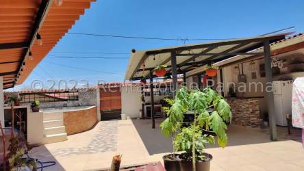 Bright kitchen with island, sliding doors, appliances, and natural light in La Chorrera house for sale