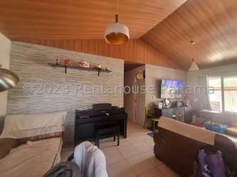 Contemporary living room with piano, sofa, TV, natural light in La Chorrera Panama home