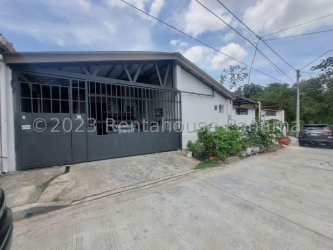 Rustic outdoor brick barbecue with metal roof in backyard patio La Chorrera Panama property