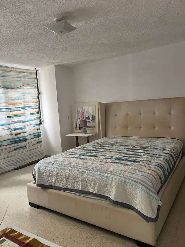 Dining area with corner windows, glass table, natural light in luxury Panama apartment