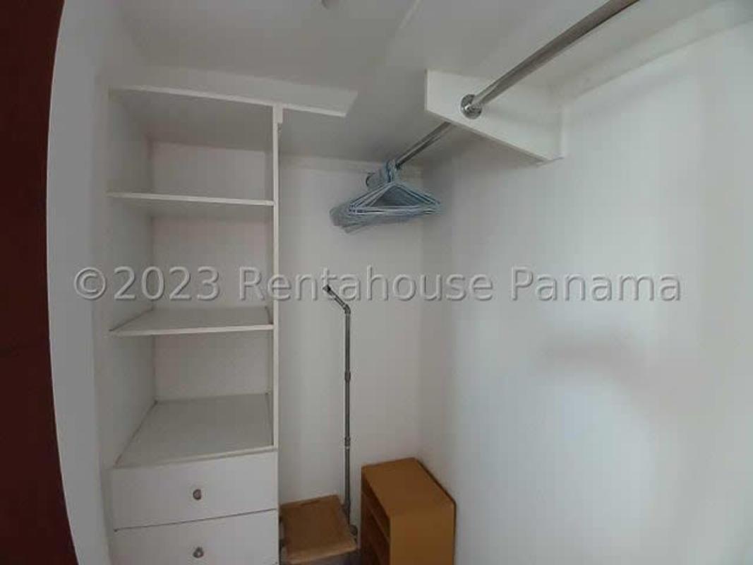 Walk-in closet with built-in storage, hanging rods, and drawers in PH Terramar San Francisco