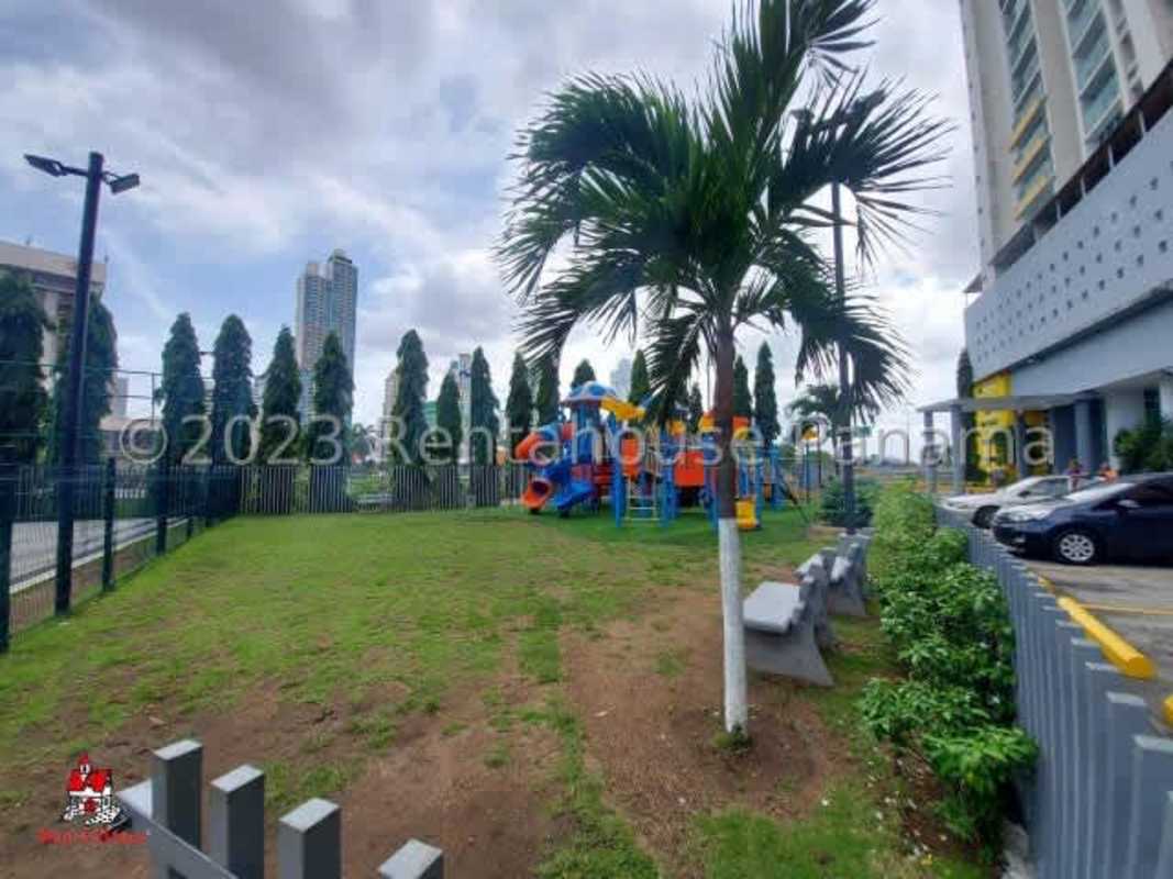 Children play area beside high-rise condo building at PH Terramar San Francisco Panama City