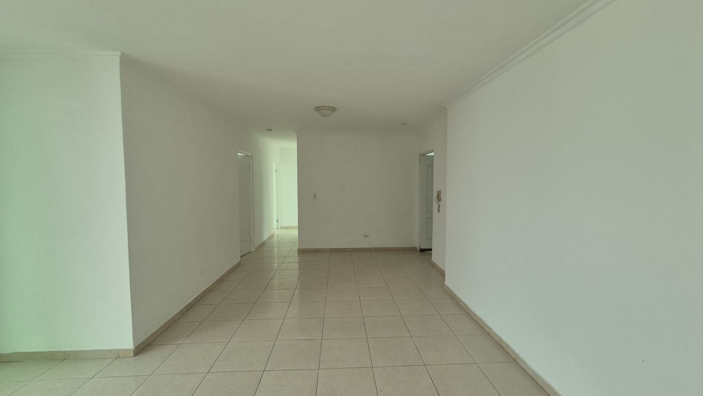 Living room with large windows overlooking Panama City skyline in PH Bella Vista