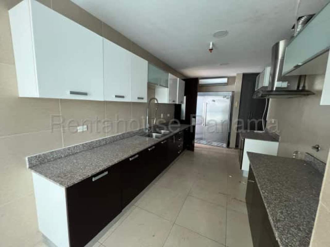 Contemporary kitchen with granite counters, stainless appliances and ample cabinets in luxury PH Ocean Point