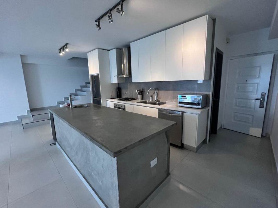 Minimalist kitchen with granite island, stainless appliances at PH BICSA Tower Panama