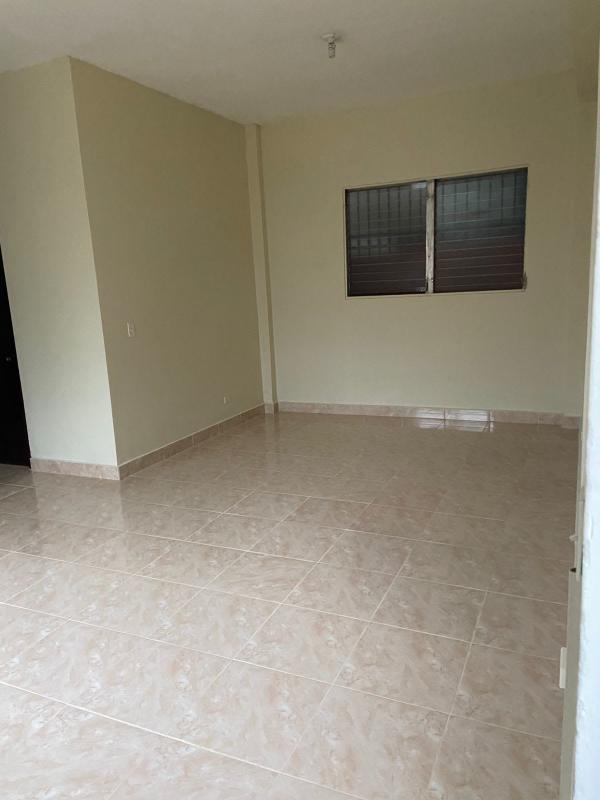 Empty interior room beige tiles and window with security bars in Parque Lefevre apartment