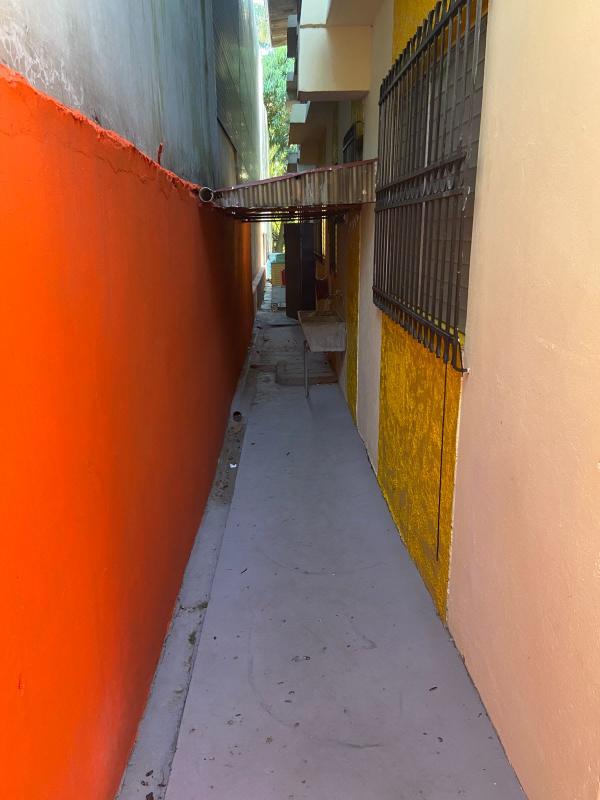 Exterior walkway with gate and vibrant walls in Parque Lefevre Panama