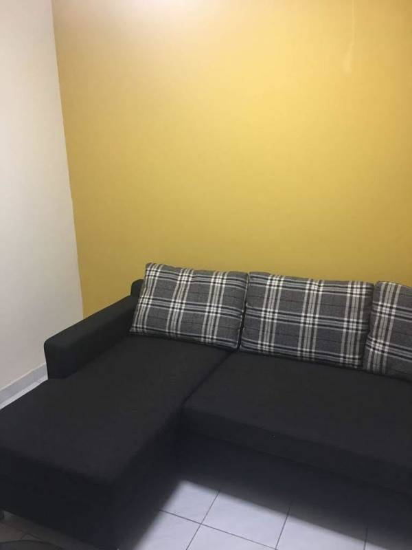 Living room with wooden doors, sofa, window bars Carrasquilla Plaza Panama