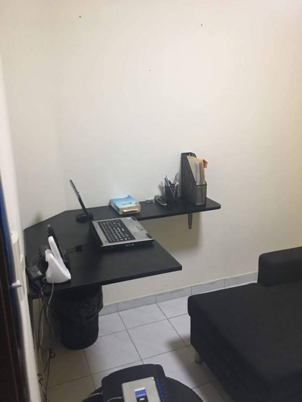 Living room corner with black curtains, grey sofa, tiled floor Carrasquilla Plaza Panama