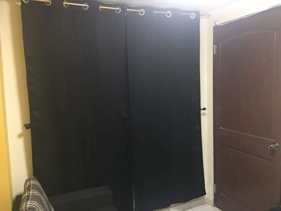 Small home office with floating desk and black couch PH Carrasquilla Plaza Panama