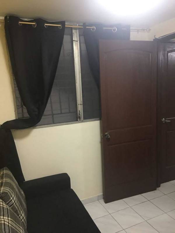 Living room with wooden door, window with bars PH Carrasquilla Plaza Panama