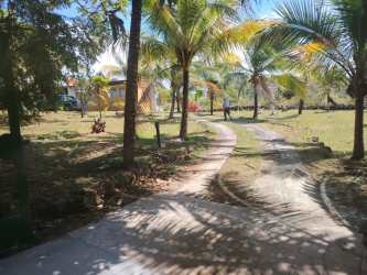 Covered outdoor patio with garden views and seating area in country rental La Laguna San Carlos Panama