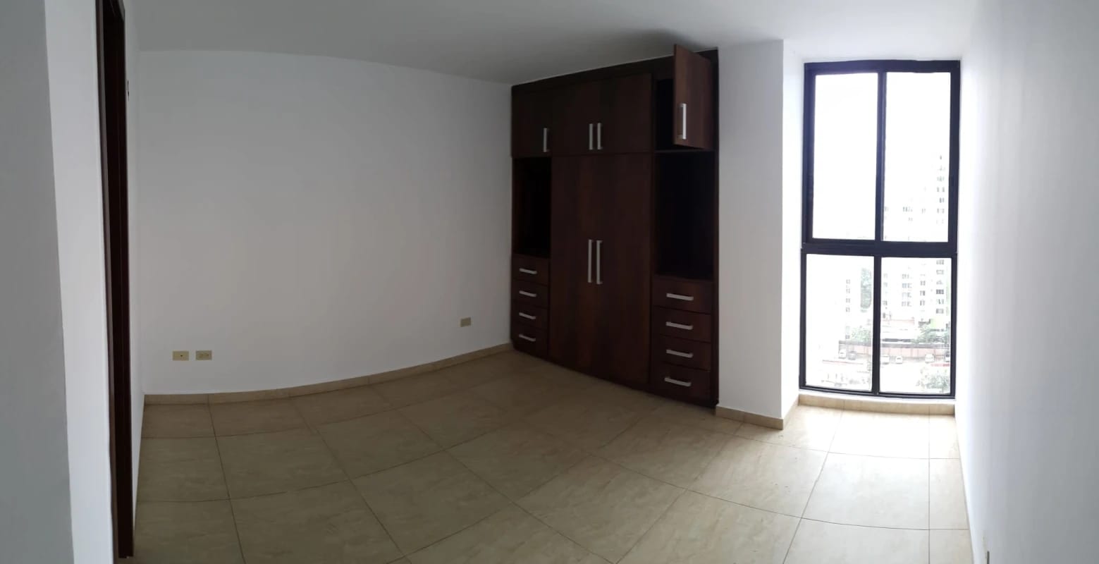 Bedroom with large window and built-in wardrobe in PH Condado Country Club Condado del Rey Panama