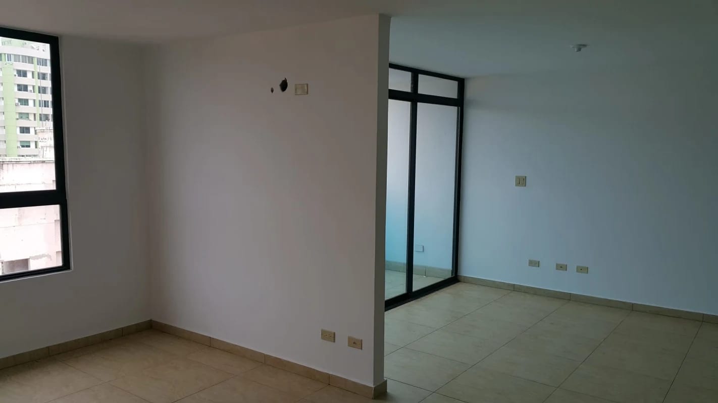Empty living room with large sliding doors to balcony tiled floors panoramic views Condado del Rey Panama rental
