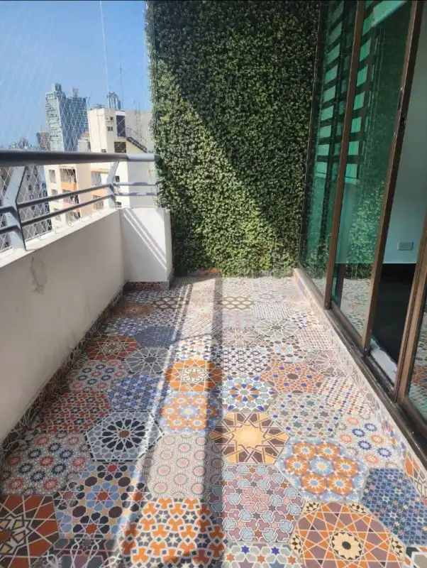 Apartment balcony with mosaic tile flooring and city views at PH Pacific Wind Punta Pacifica Panama City