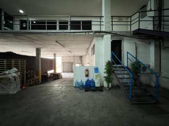 Interior view of cargo floor with ramps, storage racks, numbered bays inside operational warehouse Colon Panama