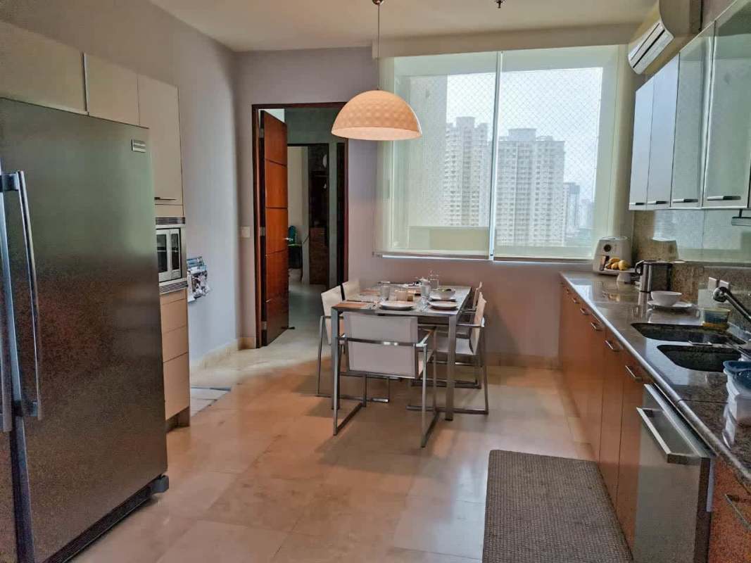 Gourmet kitchen with granite island and appliances in PH Blue Bahia Punta Pacifica apartment