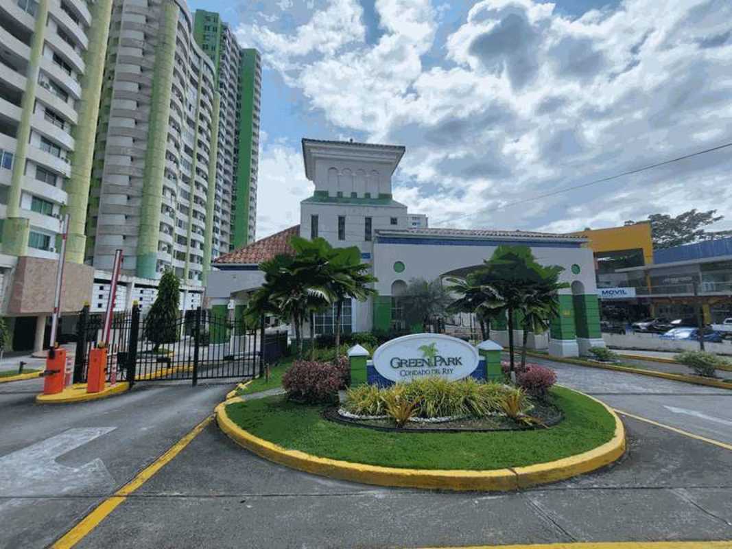 Secure gated entrance of PH Green Park residential towers with landscaped roundabout Condado del Rey Panama