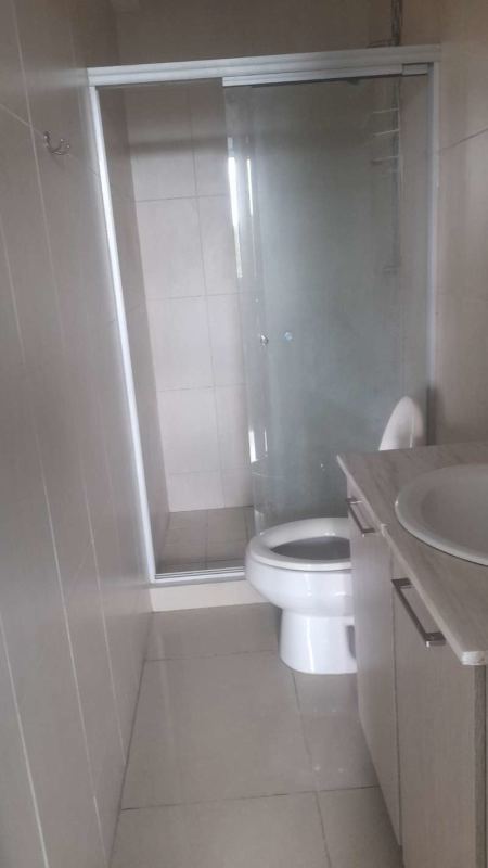 Modern bathroom with glass shower enclosure, vanity, light tile PH Green Park Condado del Rey Panama