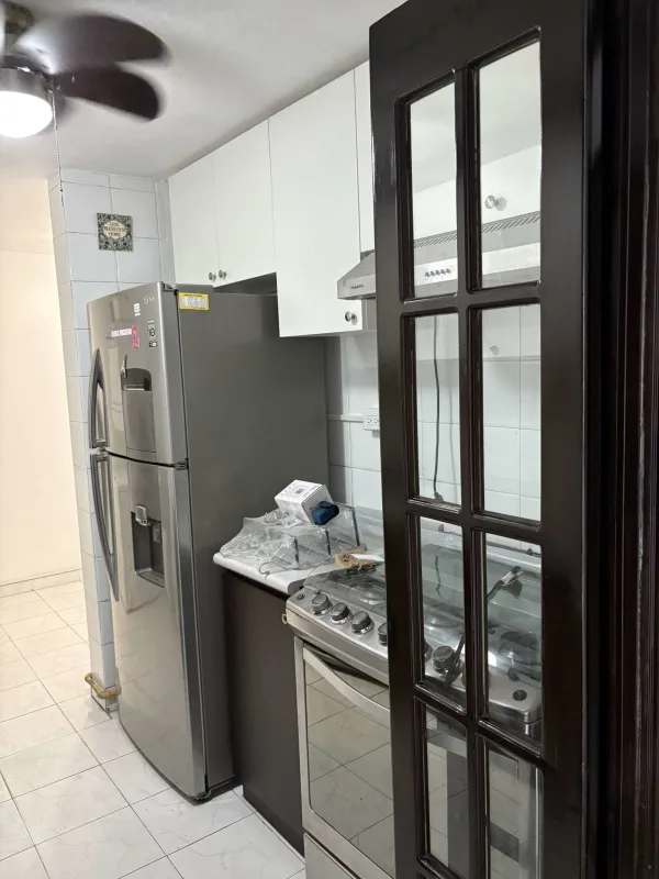 Modern kitchen with white and black cabinets, stove, refrigerator PH Lomas del Dorado Panama City