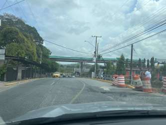 Urban street and overpass area along Vacamonte main road near potential development plot in Panama Oeste