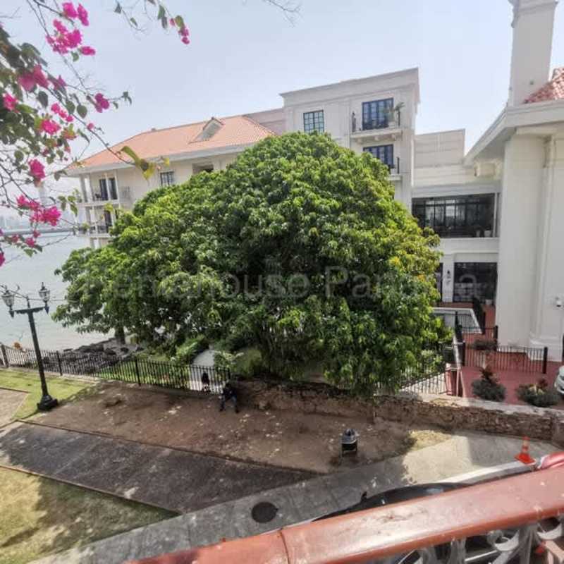 Balcony with panoramic waterfront and city skyline view at Casco Viejo apartment Panama