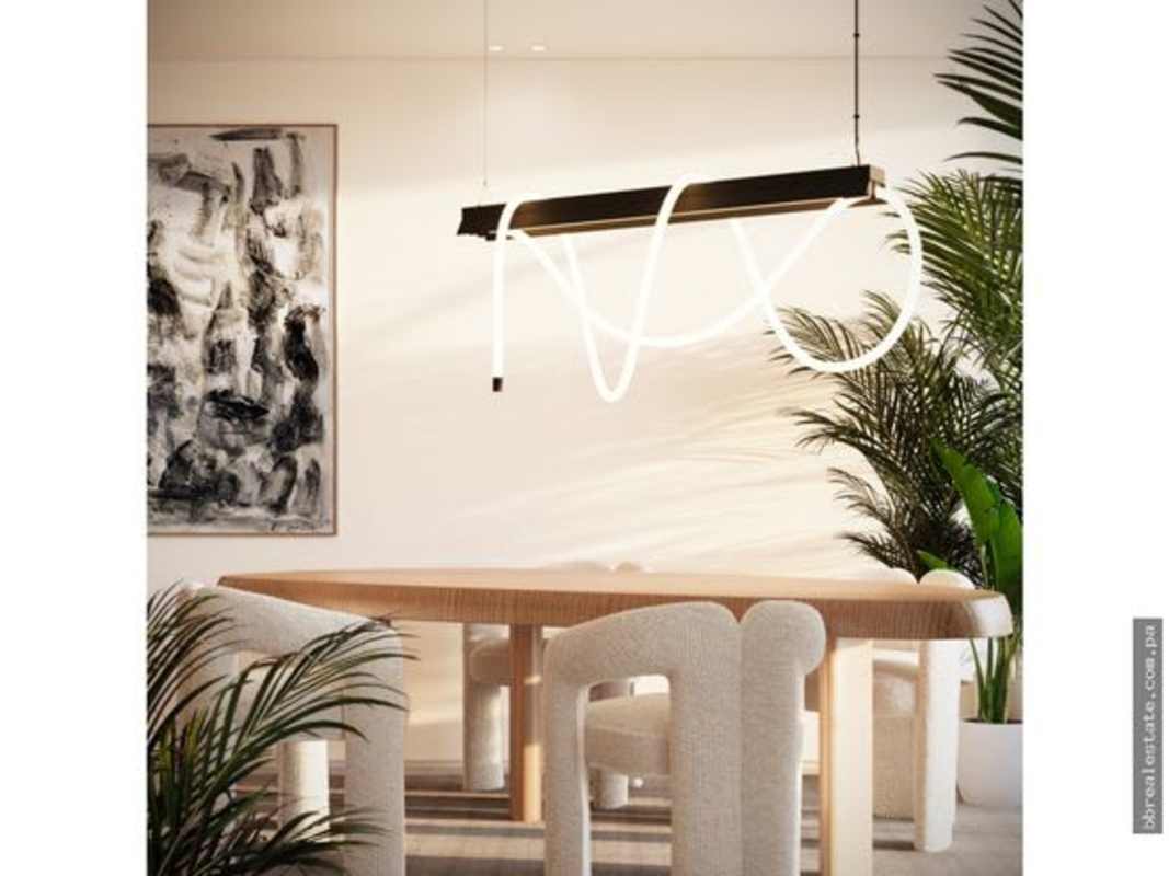 Dining area with sculptural lighting, wall art and plush chairs in PH Nautilus Amador Panama