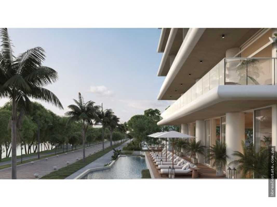 Contemporary waterfront condo with pool, lounge area and palm trees at PH Nautilus Panama