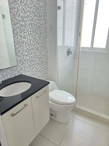 Bathroom with glass shower enclosure and granite vanity at PH Bali Costa del Este apartment for rent