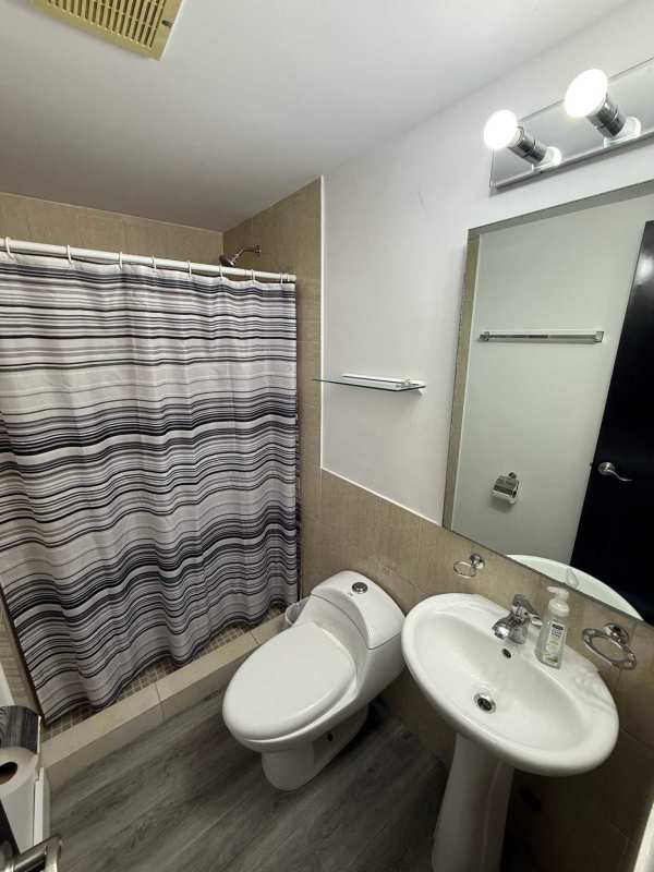 Modern bathroom with shower, pedestal sink, and tile at PH Metropolitan Park in Panama City