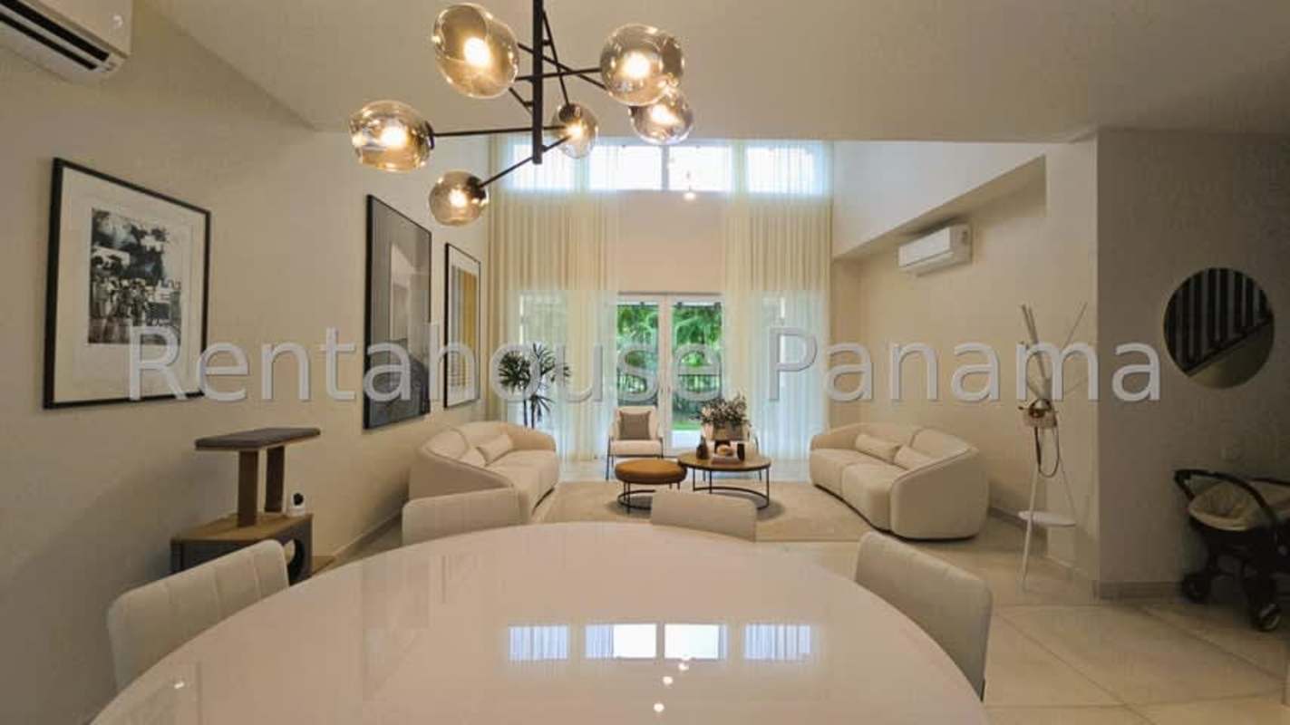 Contemporary kitchen with wood cabinetry, stainless appliances and window in Santa María Golf Panama