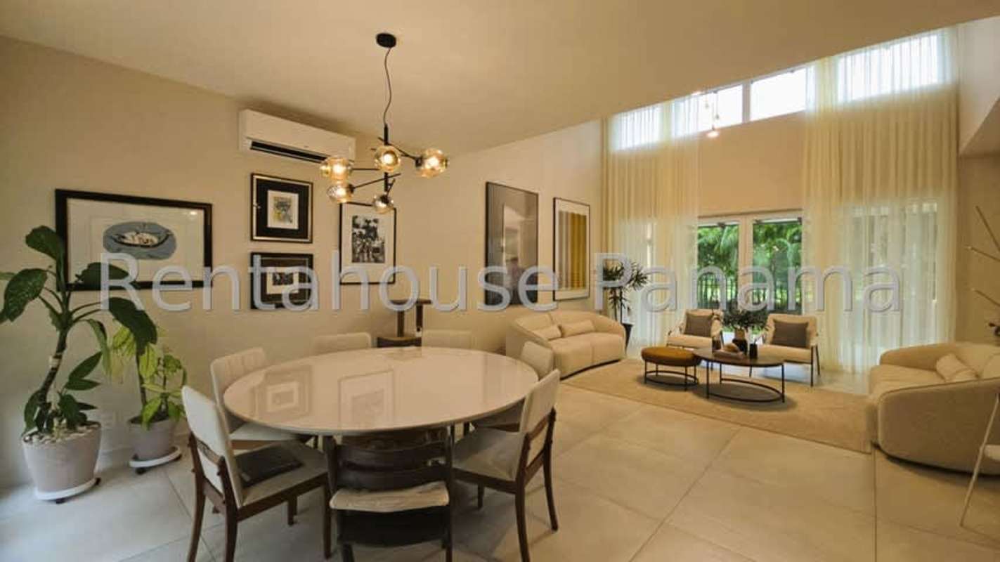 Bright living room with high ceilings, dining area and large windows in Santa María Panama luxury house