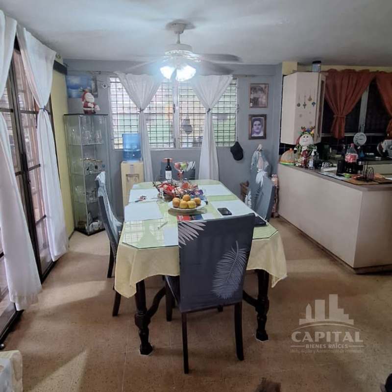 Dining room with large windows near kitchen ceiling fan Betania house Panama City sale