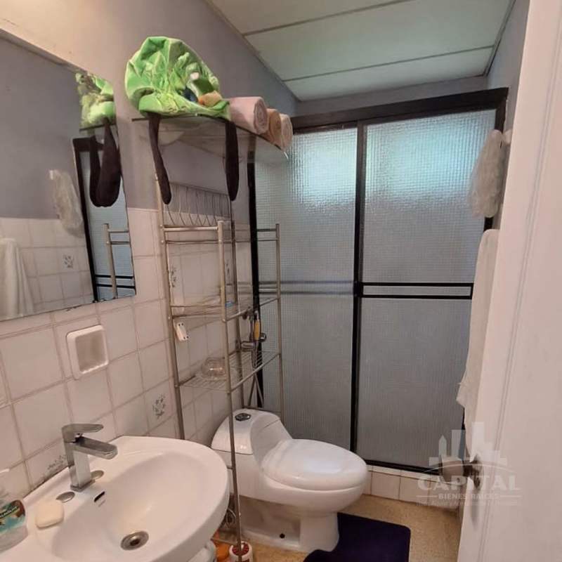 Bathroom with glass enclosed shower ceramic sink tile wall selling corner house Betania Panama City