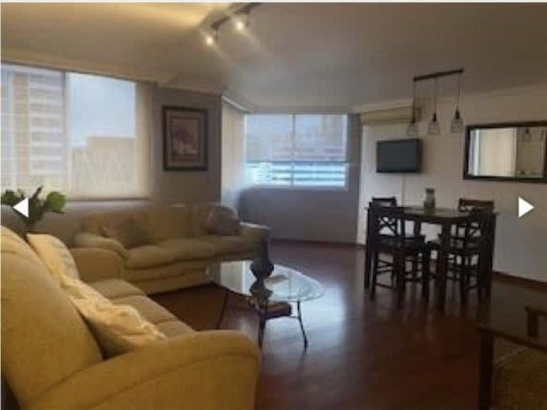 Living room with large windows and dining area in PH Las Marquesas in San Francisco Panama