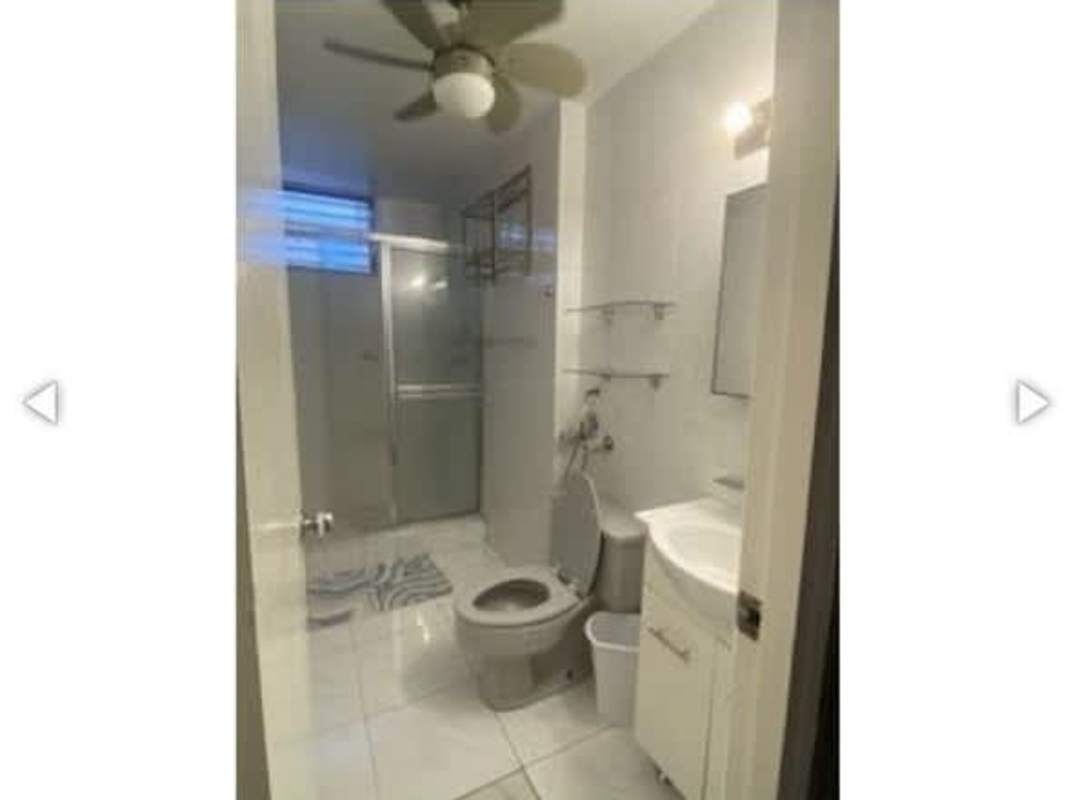 Modern bathroom with glass enclosed shower and ceiling fan in PH Las Marquesas apartment Panama City