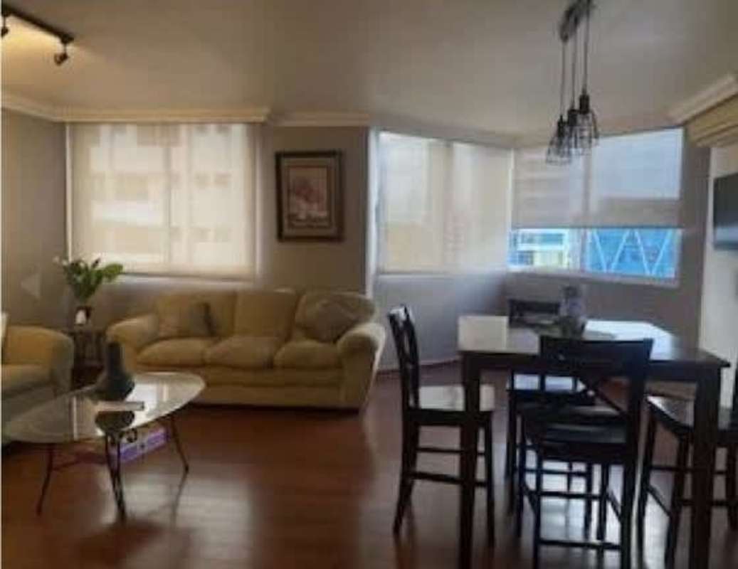 Bright living and dining area with beige sofas, large windows and contemporary decor in PH Las Marquesas San Francisco Panama