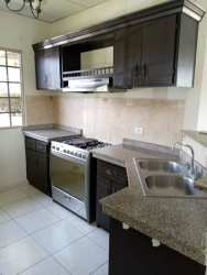 Single-story house with gated driveway and carport in La Fontana David Panama