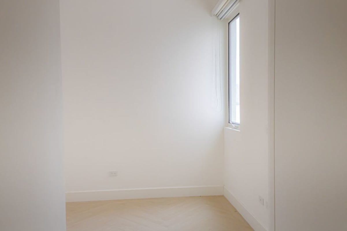 Bright minimalist hallway with glossy tiles leading to terrace Ocean Reef Islands Punta Pacifica Panama