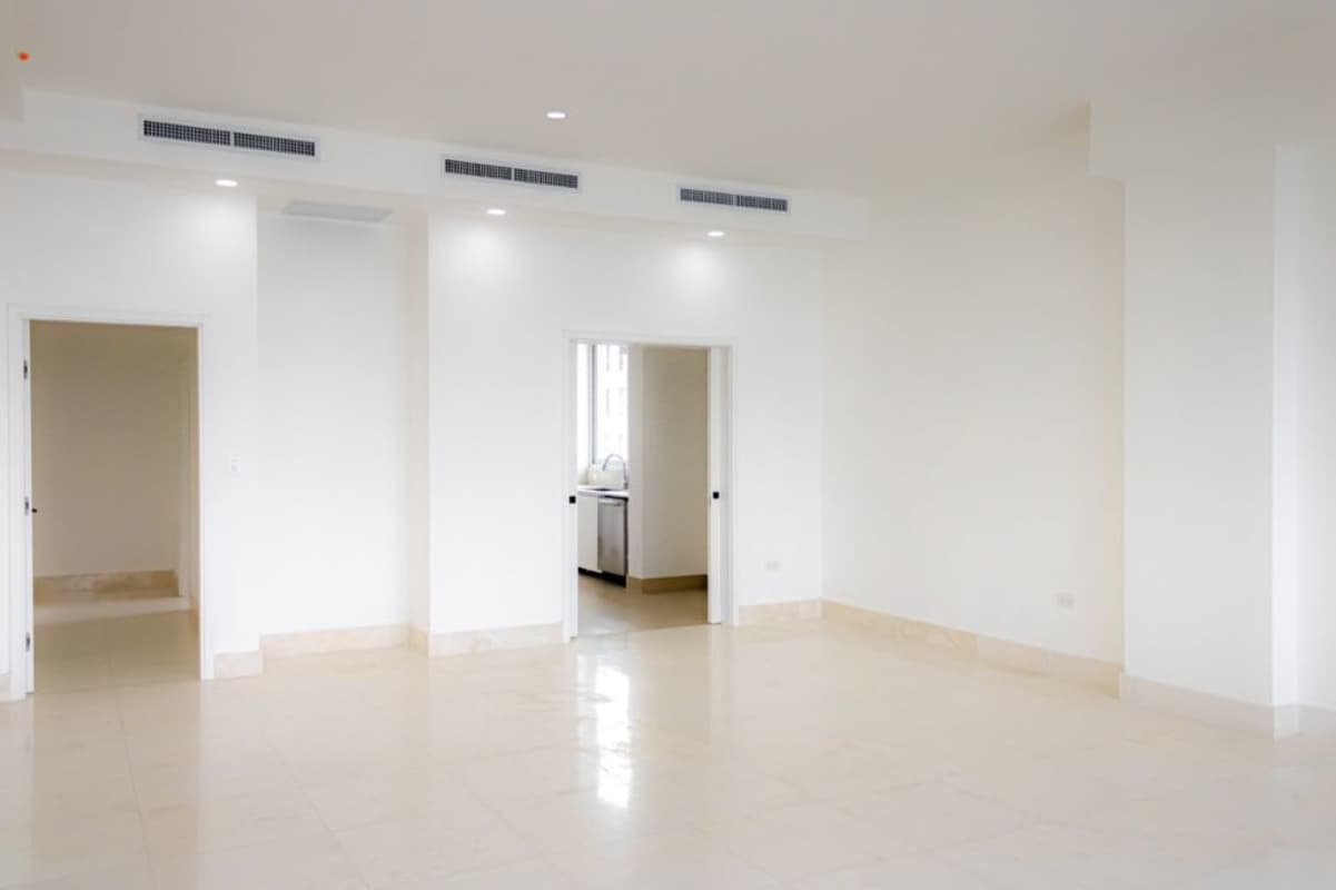 Large empty living space with tile floors air conditioning and multiple doors Ocean Reef Islands Panama