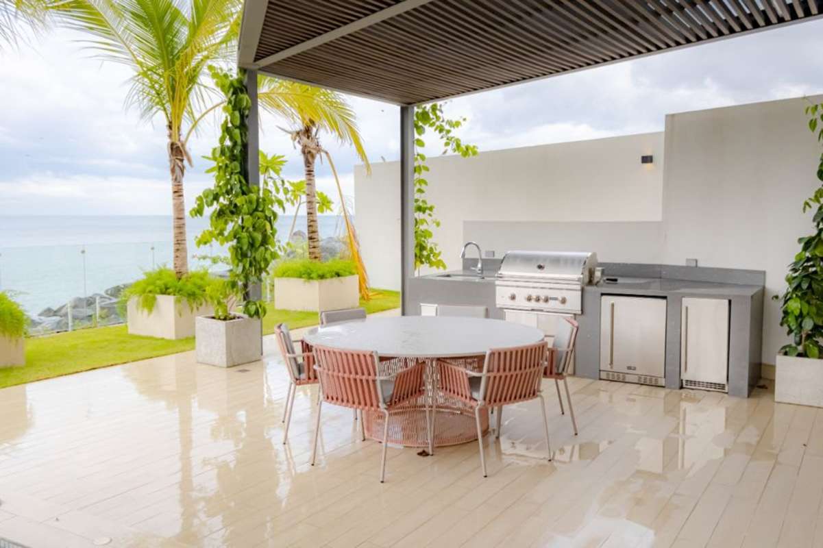 Modern patio with grill dining pergola ocean view luxury apartment Ocean Reef Panama