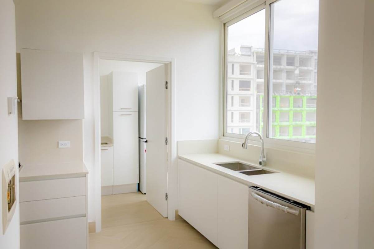 Kitchen with large window white cabinetry stainless appliances Ocean Reef Islands Panama