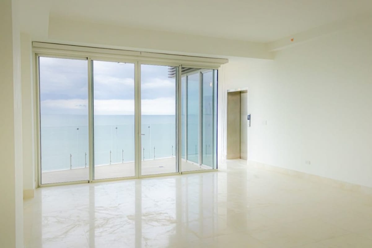 Living room with marble floors and private elevator access overlooking Pacific Ocean in Panama