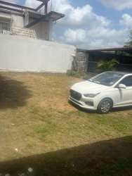 Outdoor parking lot with grass yard and perimeter wall Costa Verde Plaza La Chorrera Panama