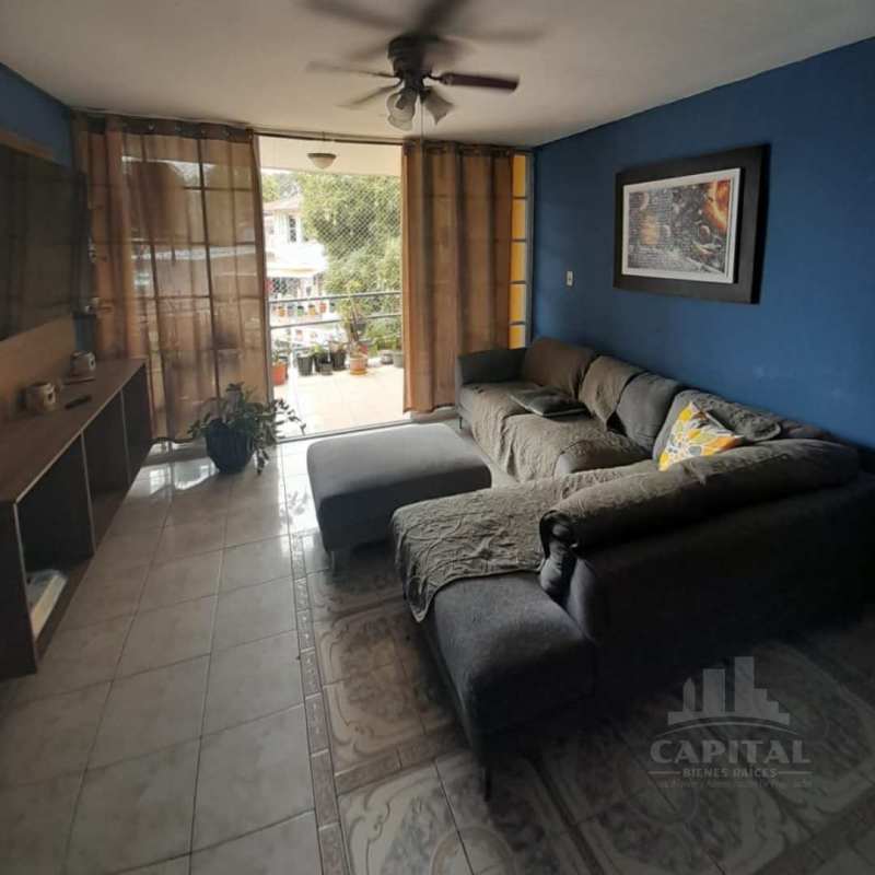 Living room with sectional sofa, sliding doors to balcony, ceiling fan in PH Terrano Panama City