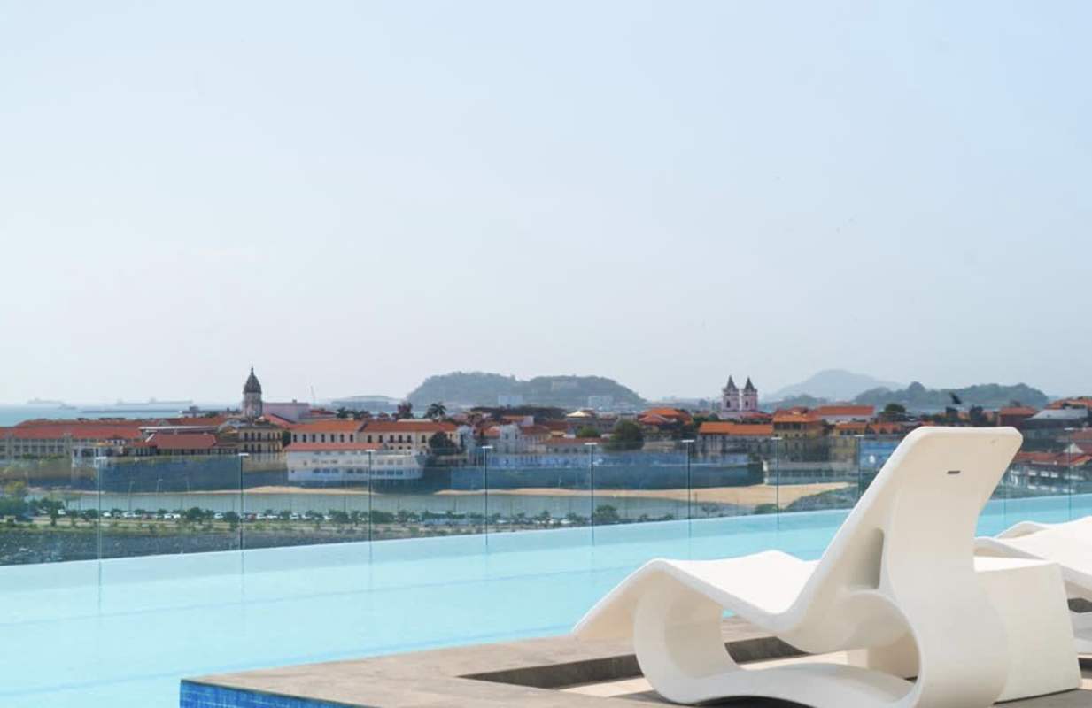 Bedroom with large window ocean view, marble floors, blackout blinds in PH BICSA Avenida Balboa Panama City