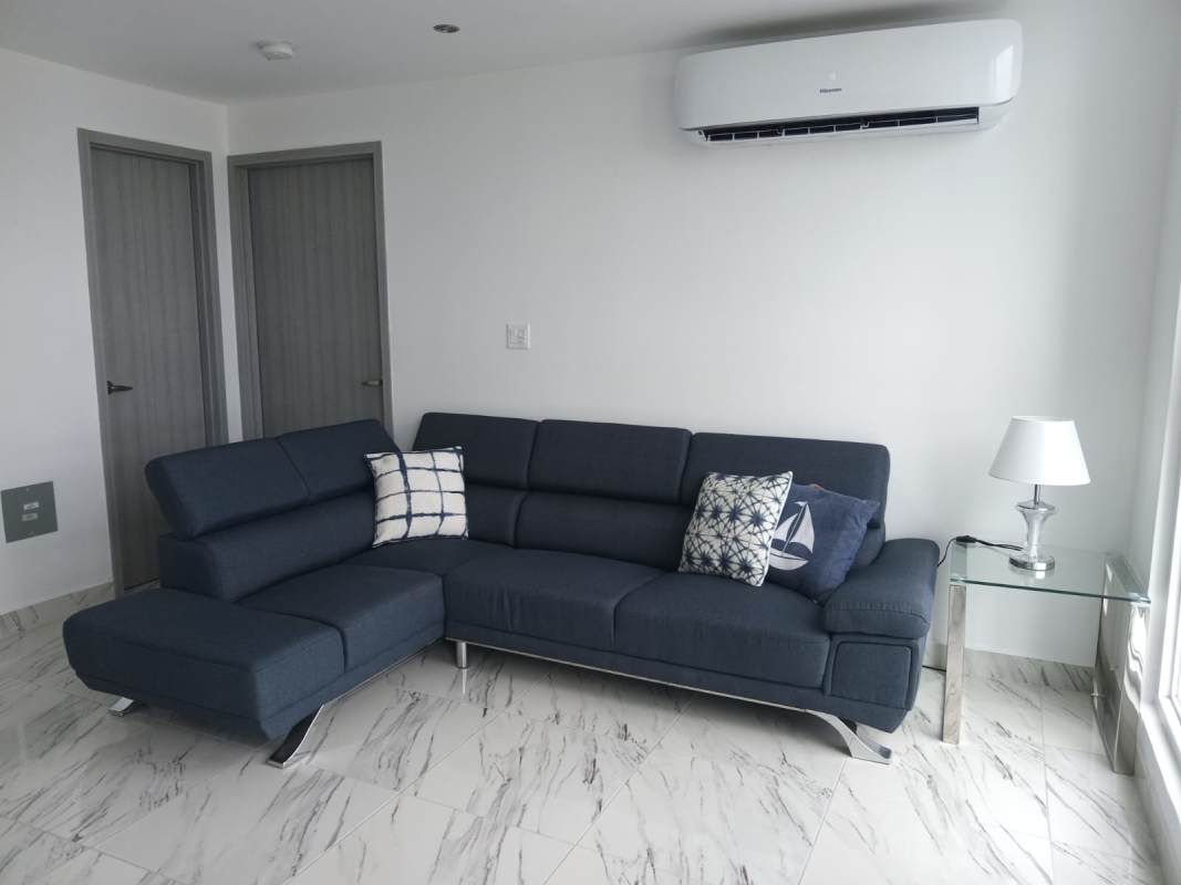 Modern living room navy sofa, marble tile, natural light, AC PH BICSA Panama