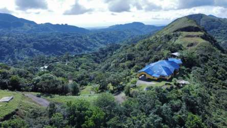Private estate blue roof and green forest surroundings Cerro Tigre El Valle Panama aerial