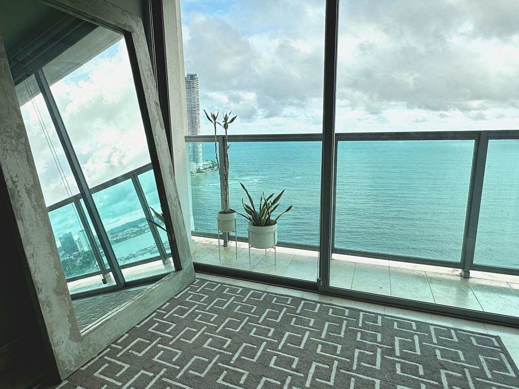 Floor-to-ceiling glass windows with panoramic ocean and skyline views in Yoo Panama Panama City