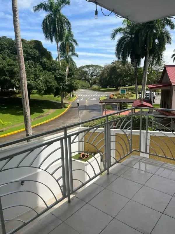 Minimalist furnished living room with large windows and garden view PH Albrook Gardens Panama